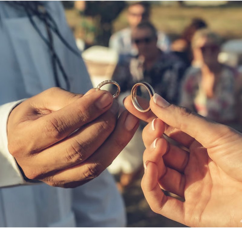 Hands holding rings at a wedding
